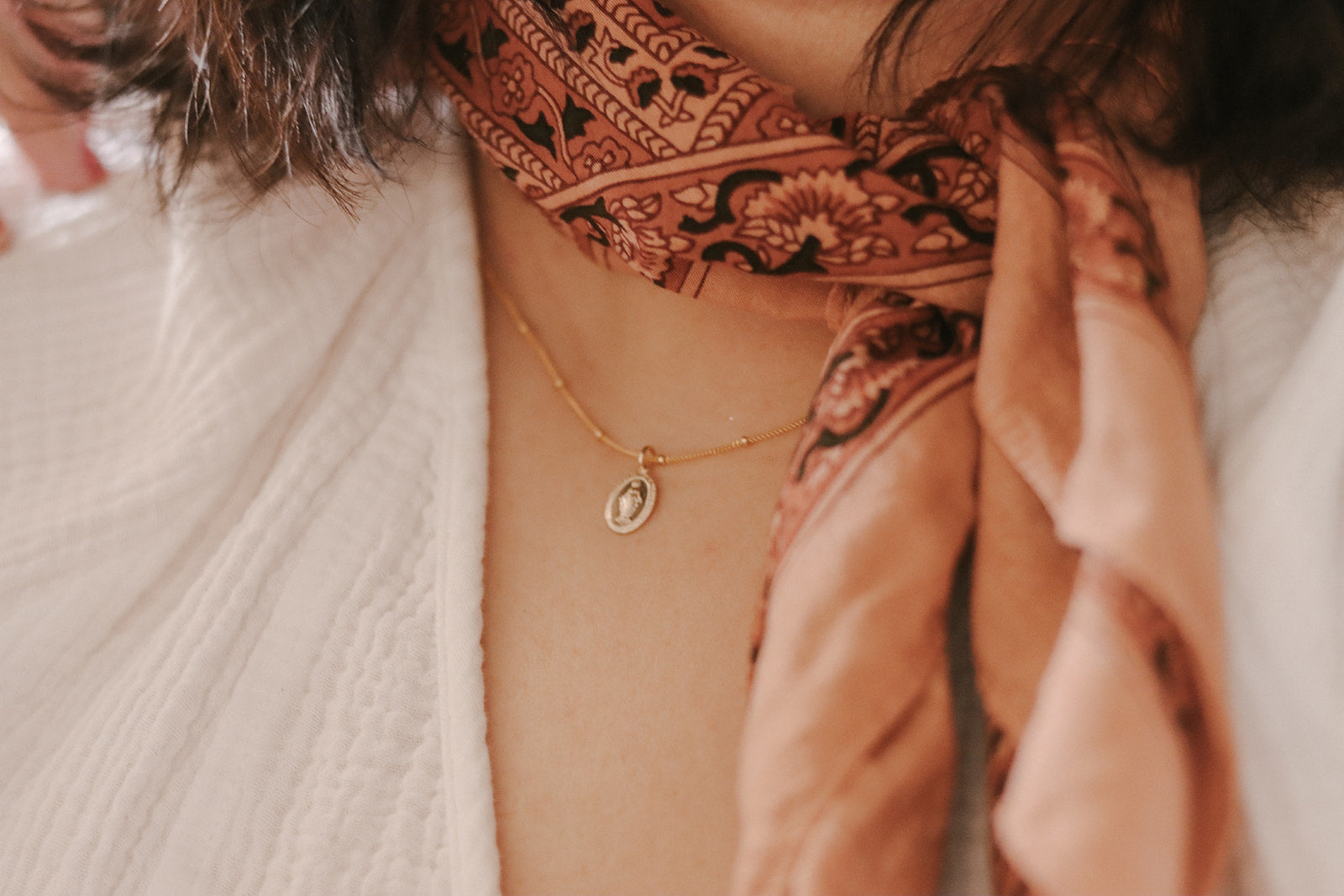 Gold-tone Miraculous Medal necklace with oval pendant and delicate chain
