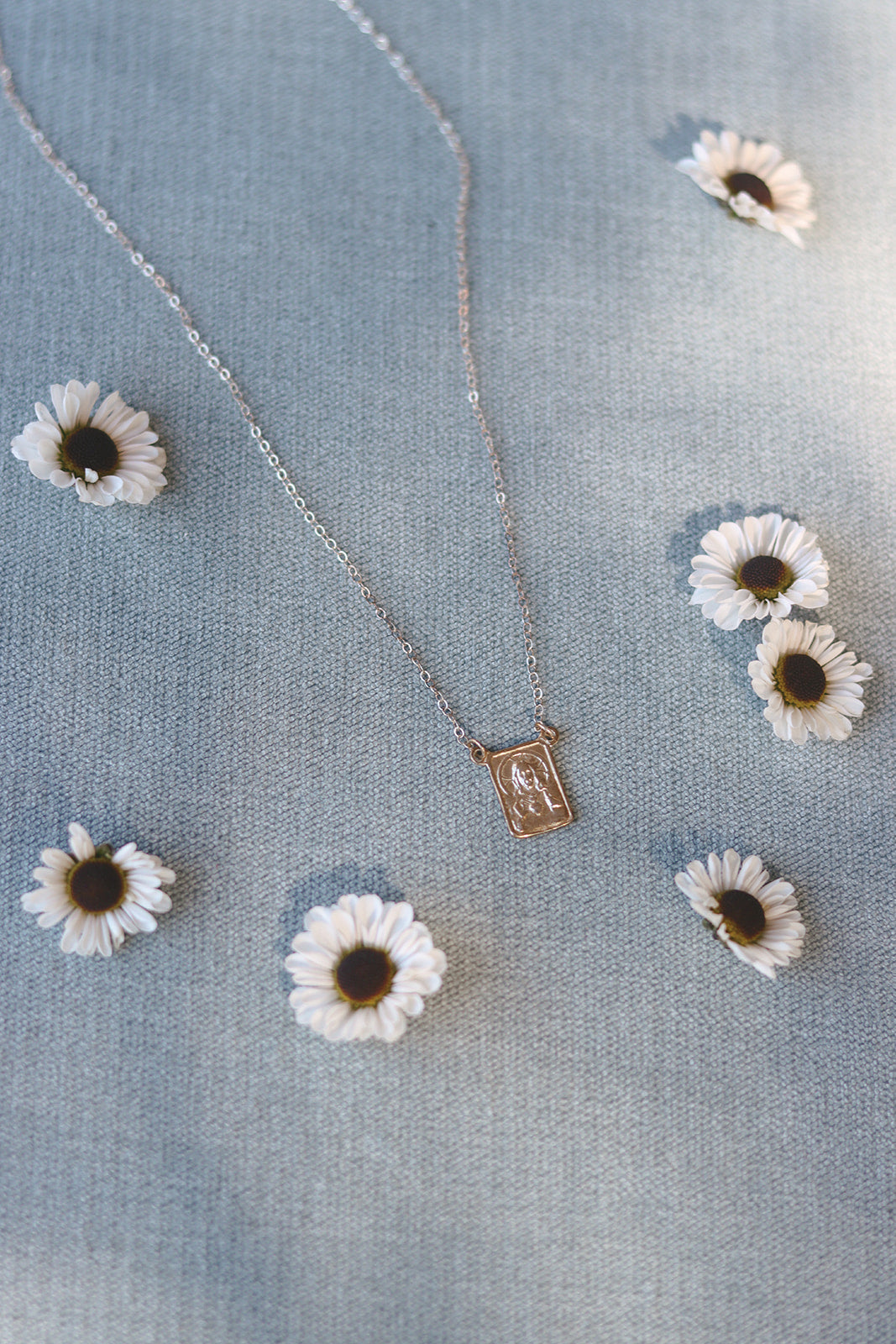 Silver scapular necklace with rectangular saint medal pendant on thin silver chain