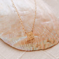 Gold paperclip scapular necklace with square portrait pendant on chain