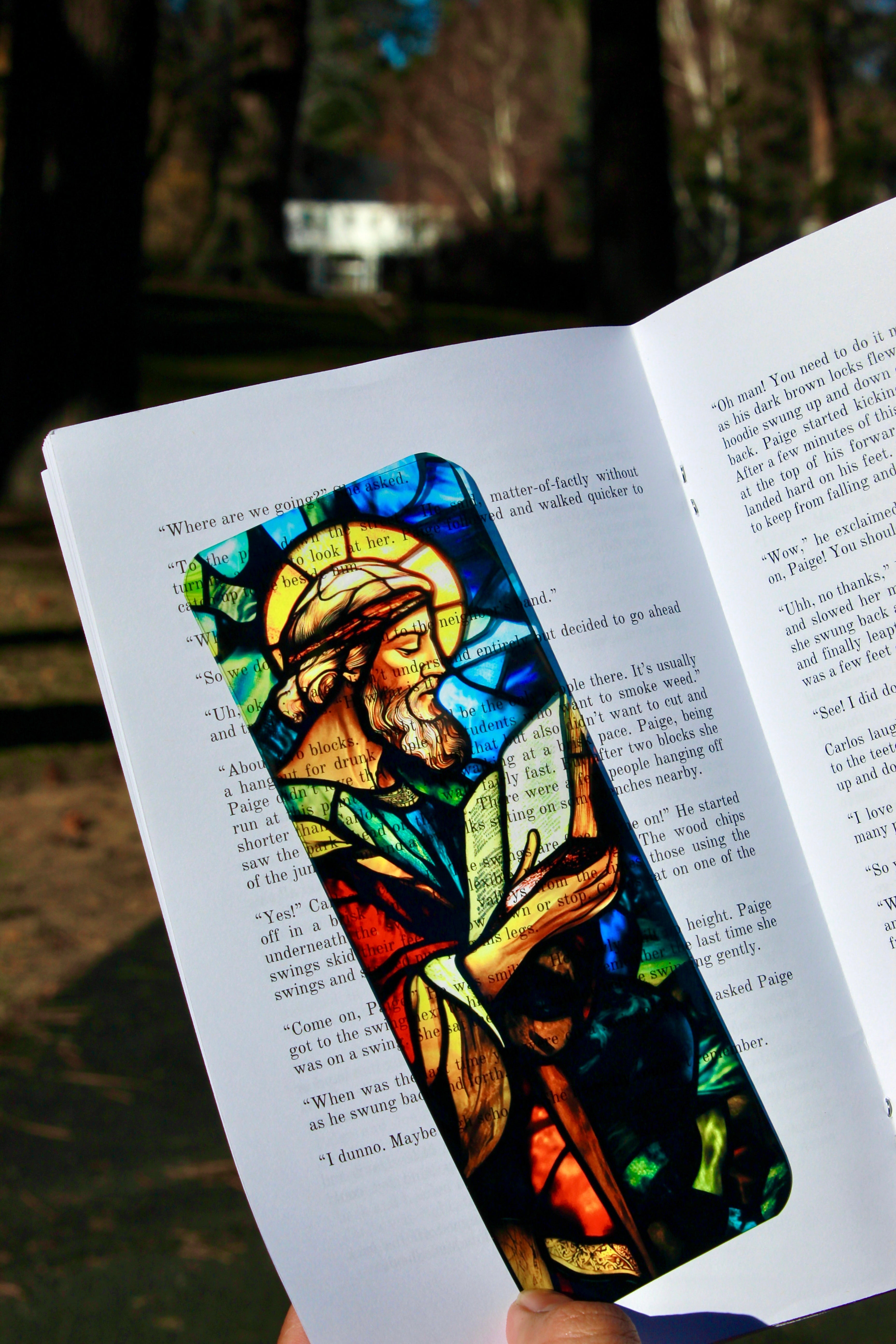 Stained-glass style Christian bookmark featuring angel in blue, red, and green