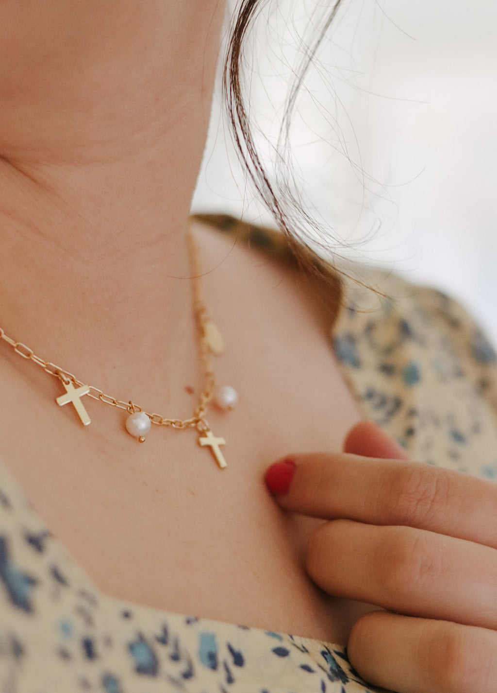 Gold cross and pearl necklace with small cross pendants at neckline