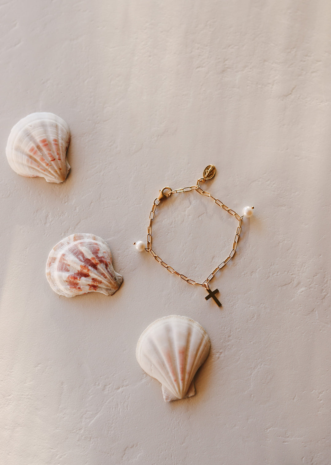 Set of two gold-tone beaded bracelets with cross charms and white pearl accents