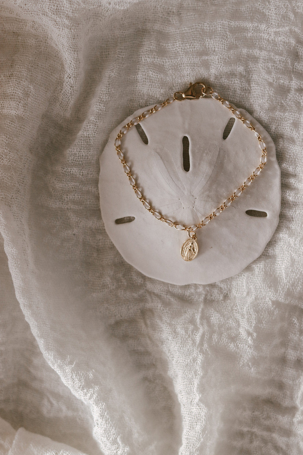 Miraculous Medal bracelet with gold oval charm and white scalloped backing