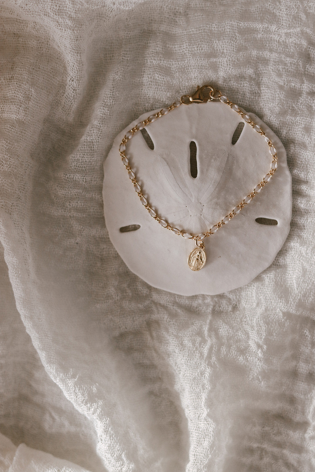 Miraculous Medal bracelet with gold oval charm and white scalloped backing