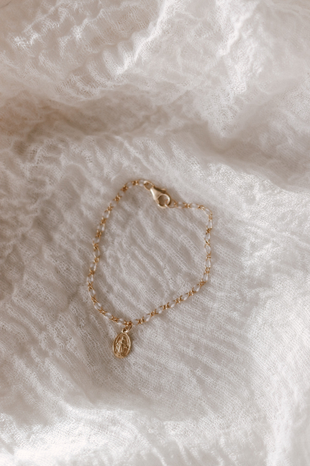 Gold chain bracelet with small oval Miraculous Medal charm