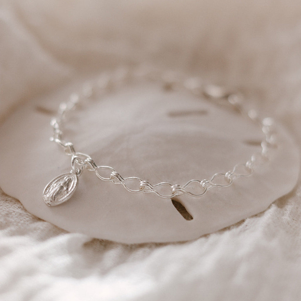 Sterling silver charm bracelet with oval Marian medallion and linked chain