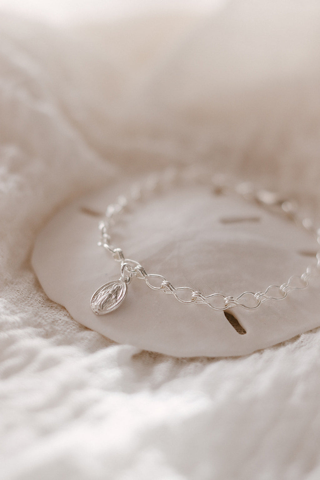 Sterling silver charm bracelet with oval Marian medallion charm and curved chain links