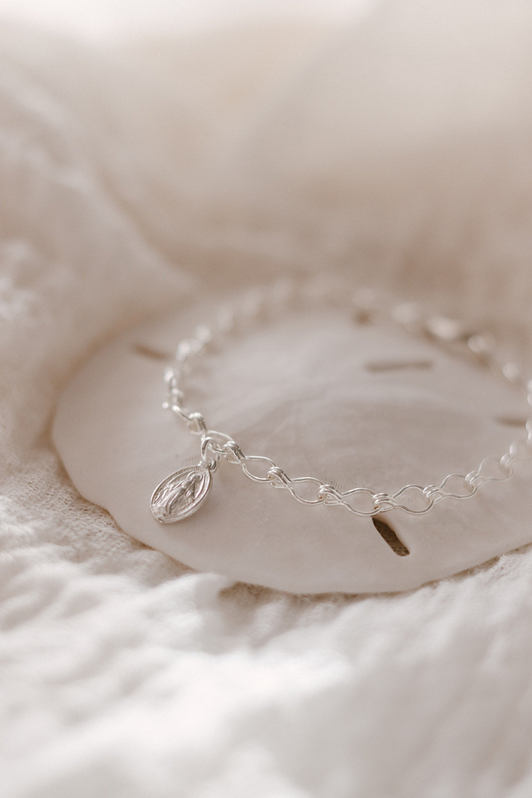 Sterling silver charm bracelet with oval Marian medallion charm and curved chain links