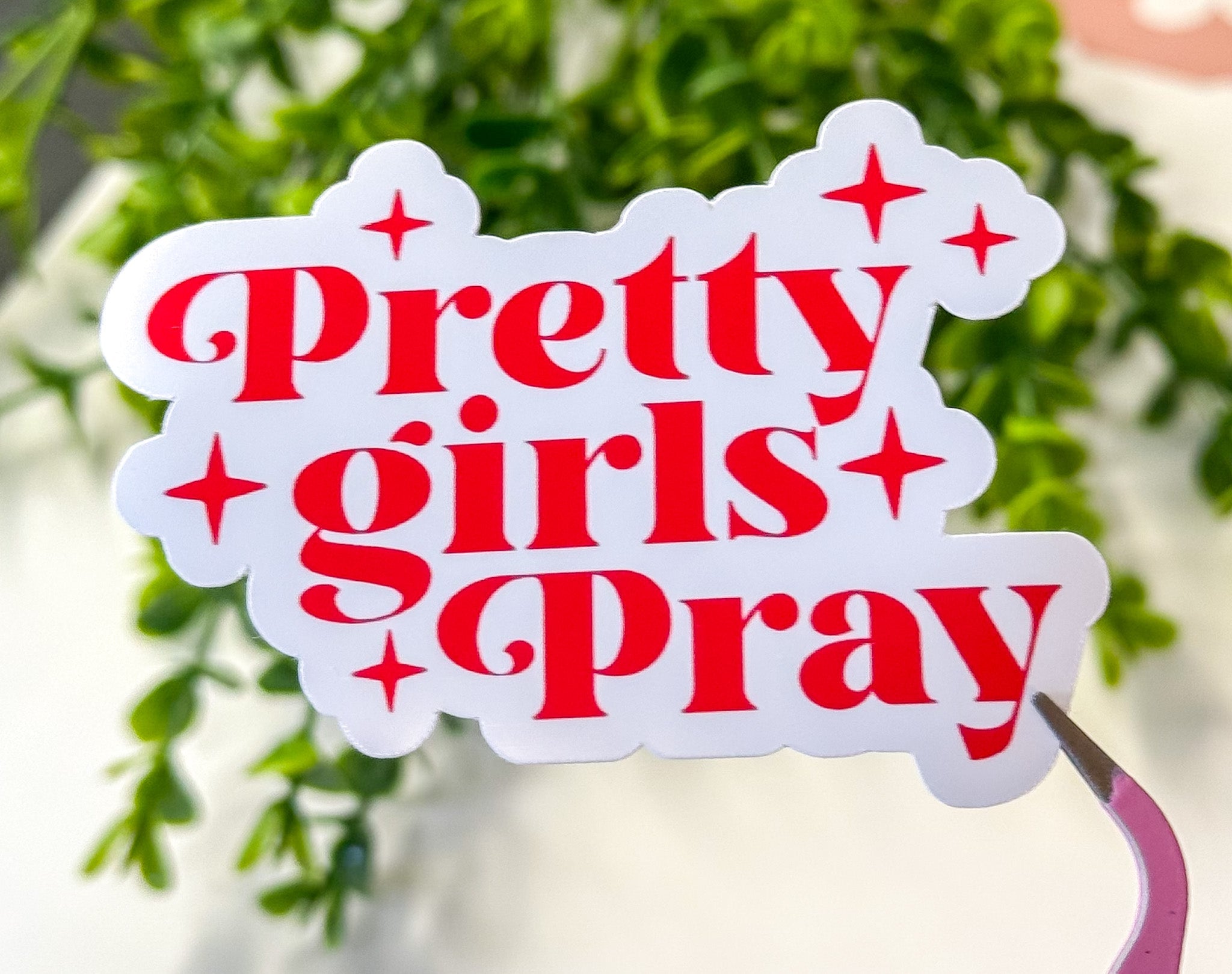 Pretty Girls Pray sticker in red lettering with star icons on a white outline