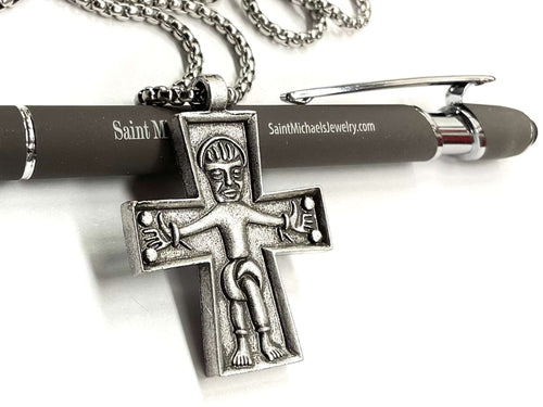 Silver cross pendant necklace with Jesus figure, shown on chain links