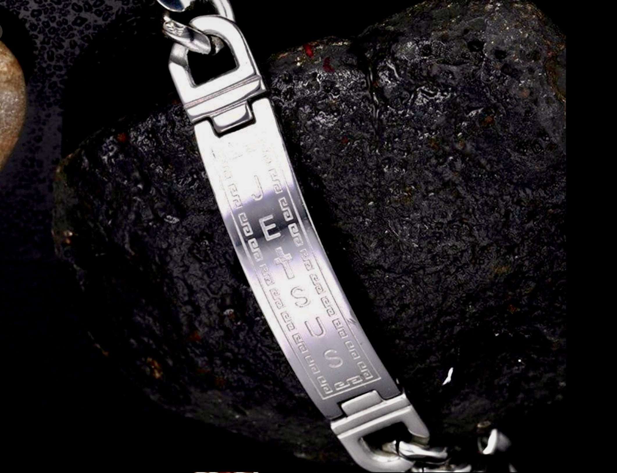 Silver-tone chain cuff bracelet close-up with engraved center and linked clasp