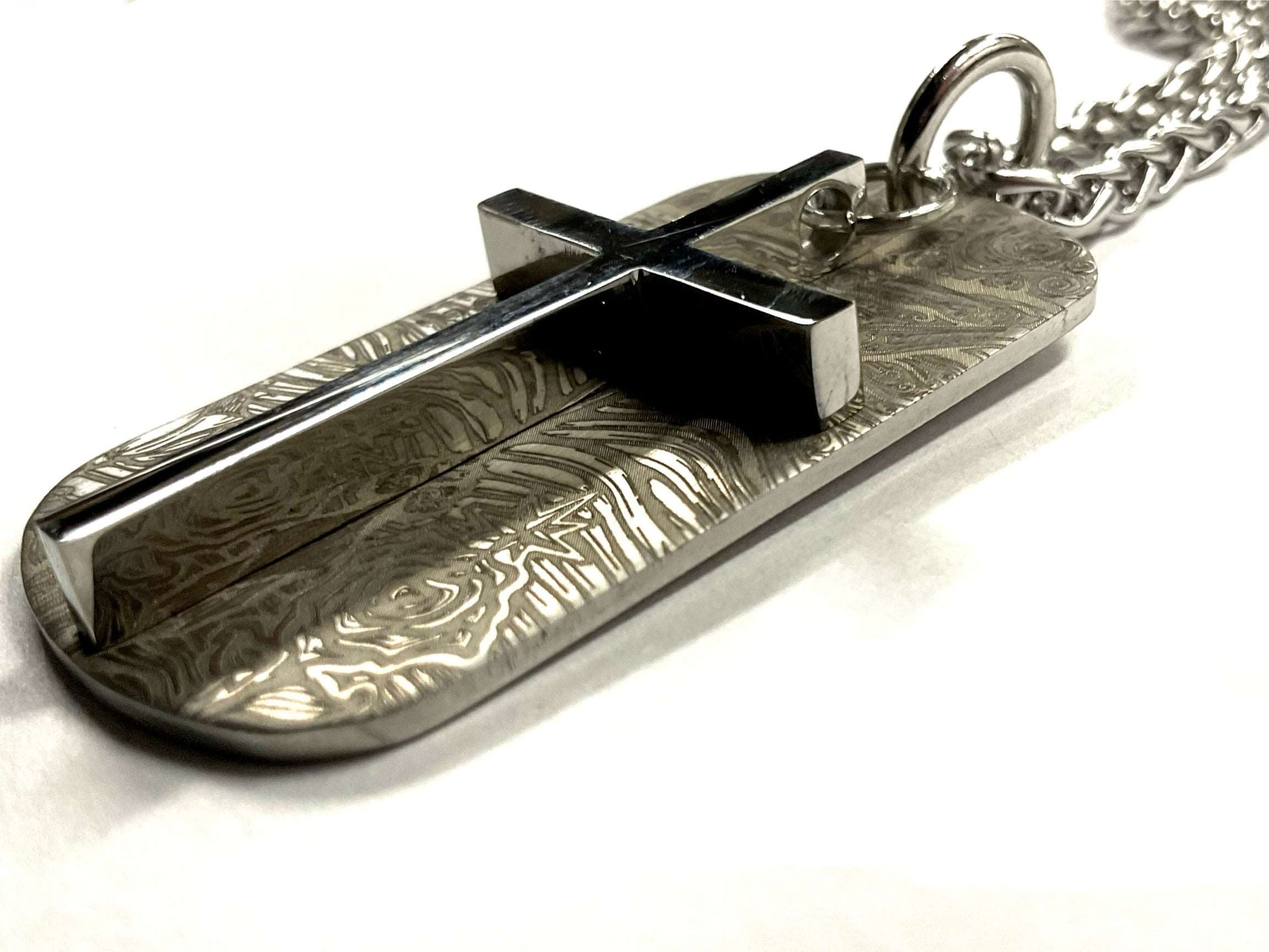 Engraved dog tag pendant with cross overlay and chain, silver-toned