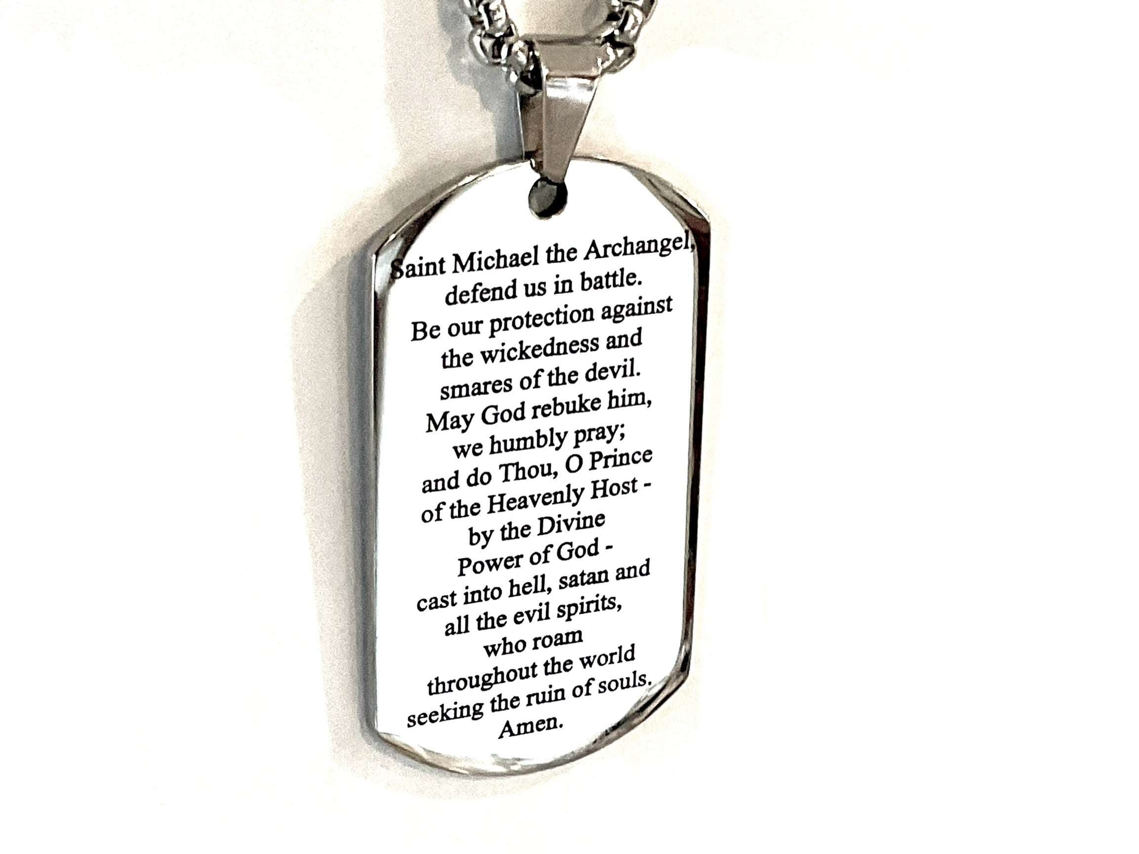 Silver dog tag necklace with engraved prayer on pendant face and metal chain.