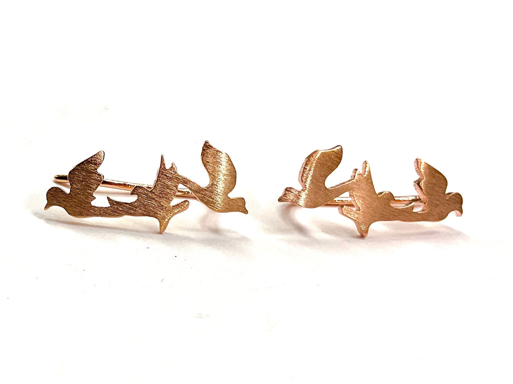 Copper dove and peace branch stud earrings, pair laid flat on white