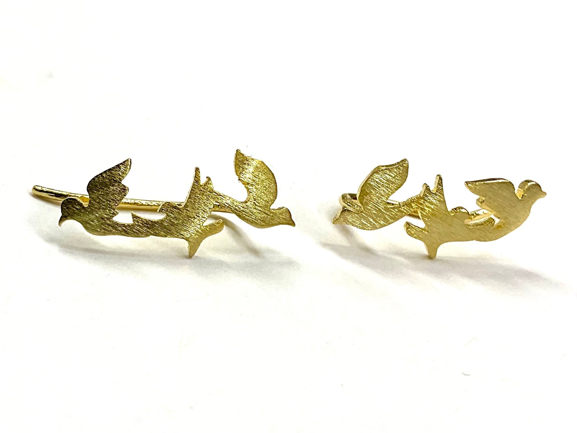 Gold dove and peace branch stud earrings, pair laid flat on white