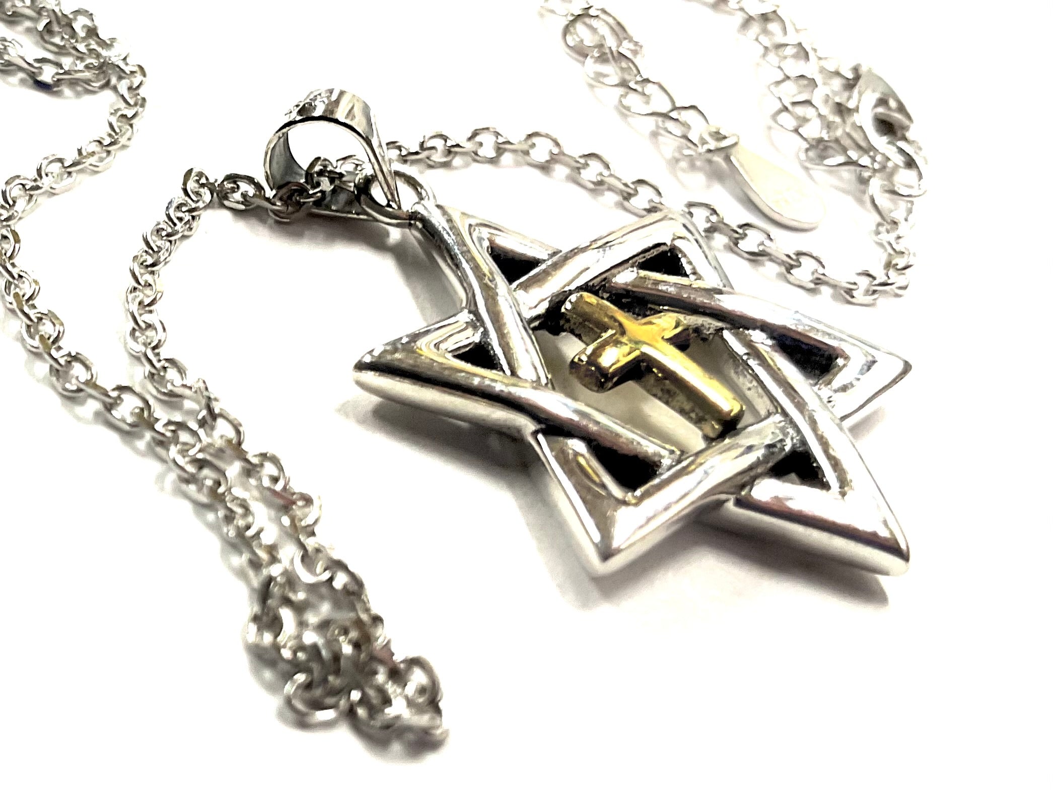 Close-up silver Star of David pendant with gold inlaid cross centerpiece