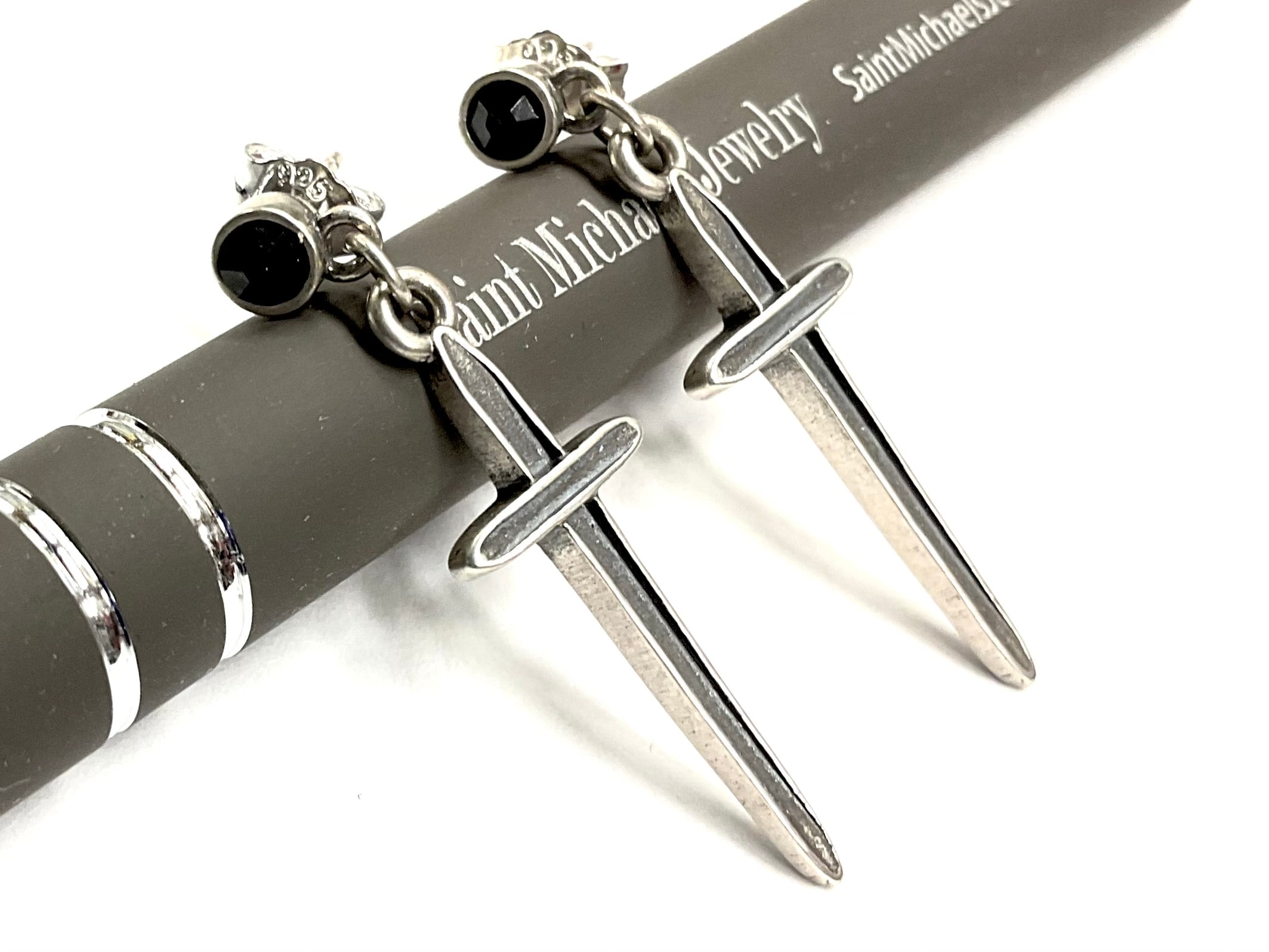 Sterling silver dangle earrings with black onyx round tops and dagger pendant drops