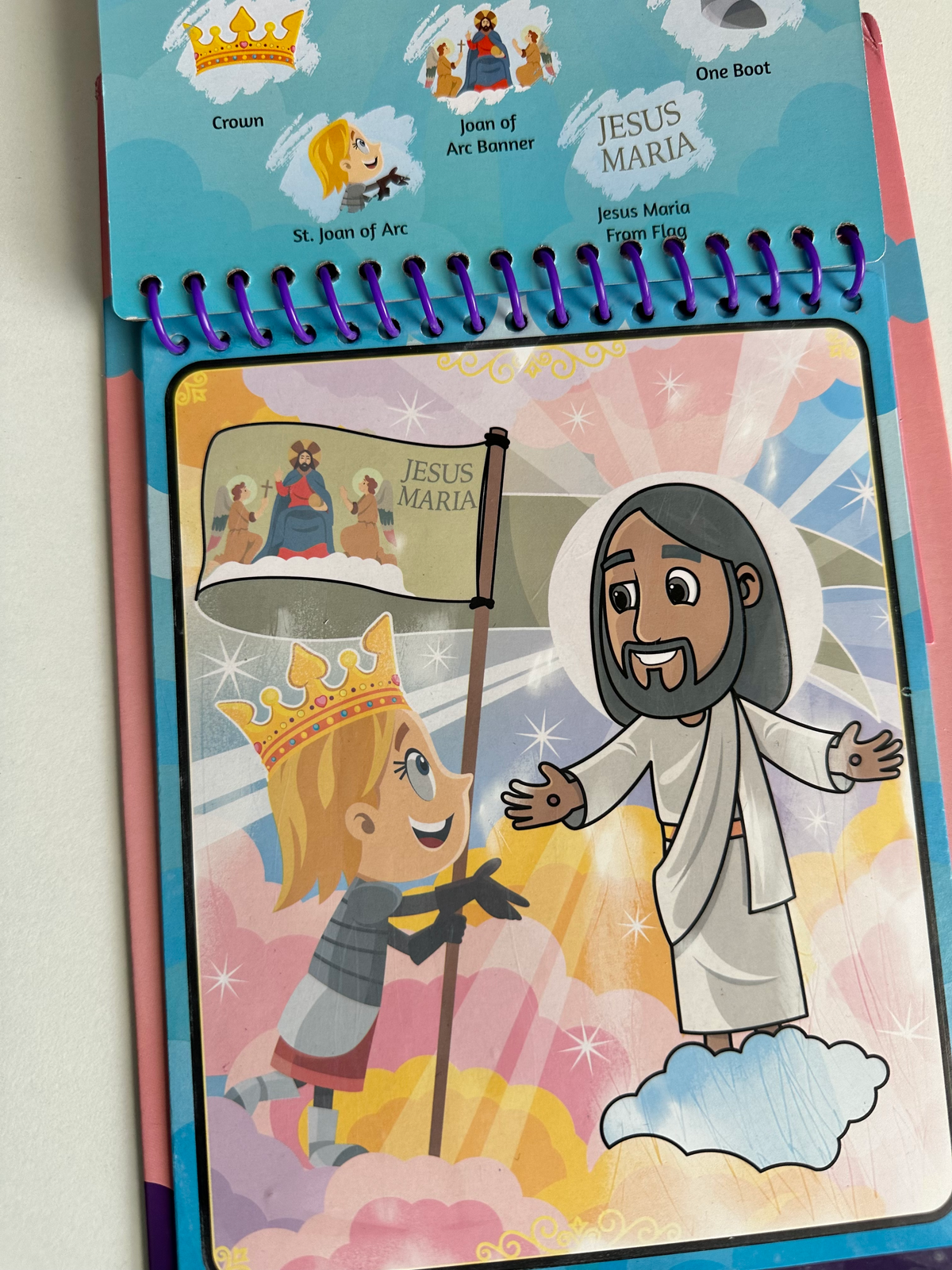 Kids coloring book page featuring Jesus Maria and Joan of Arc characters on spiral binding
