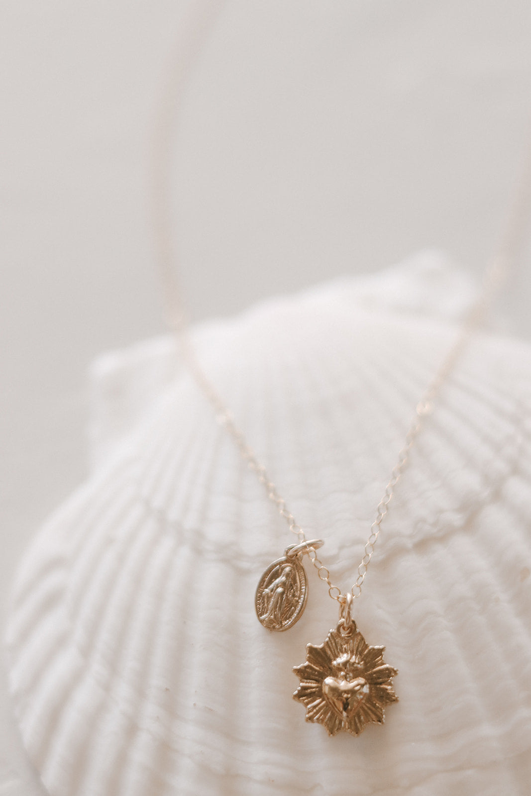 Gold heart and Miraculous Medal necklace with two small pendants on chain