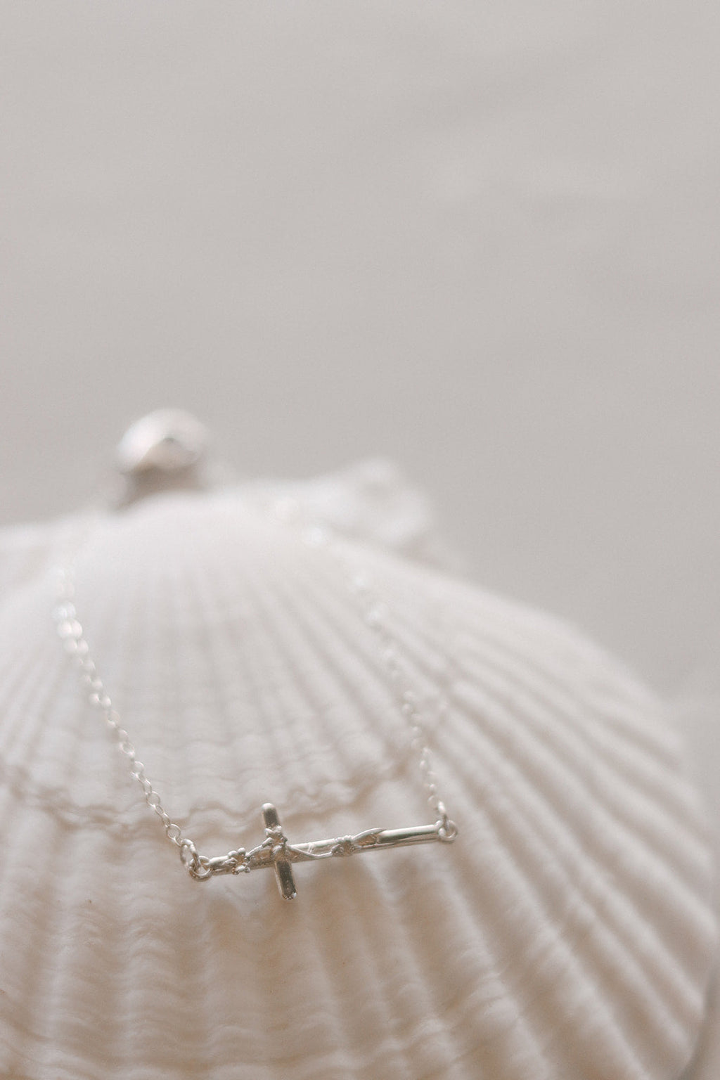 Silver cross bracelet with hinge clasp and small cross charm