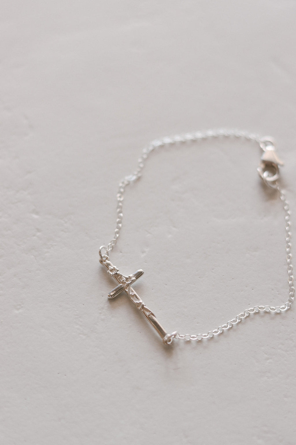 Silver cross bracelet with cross pendant, fine chain, and round clasp