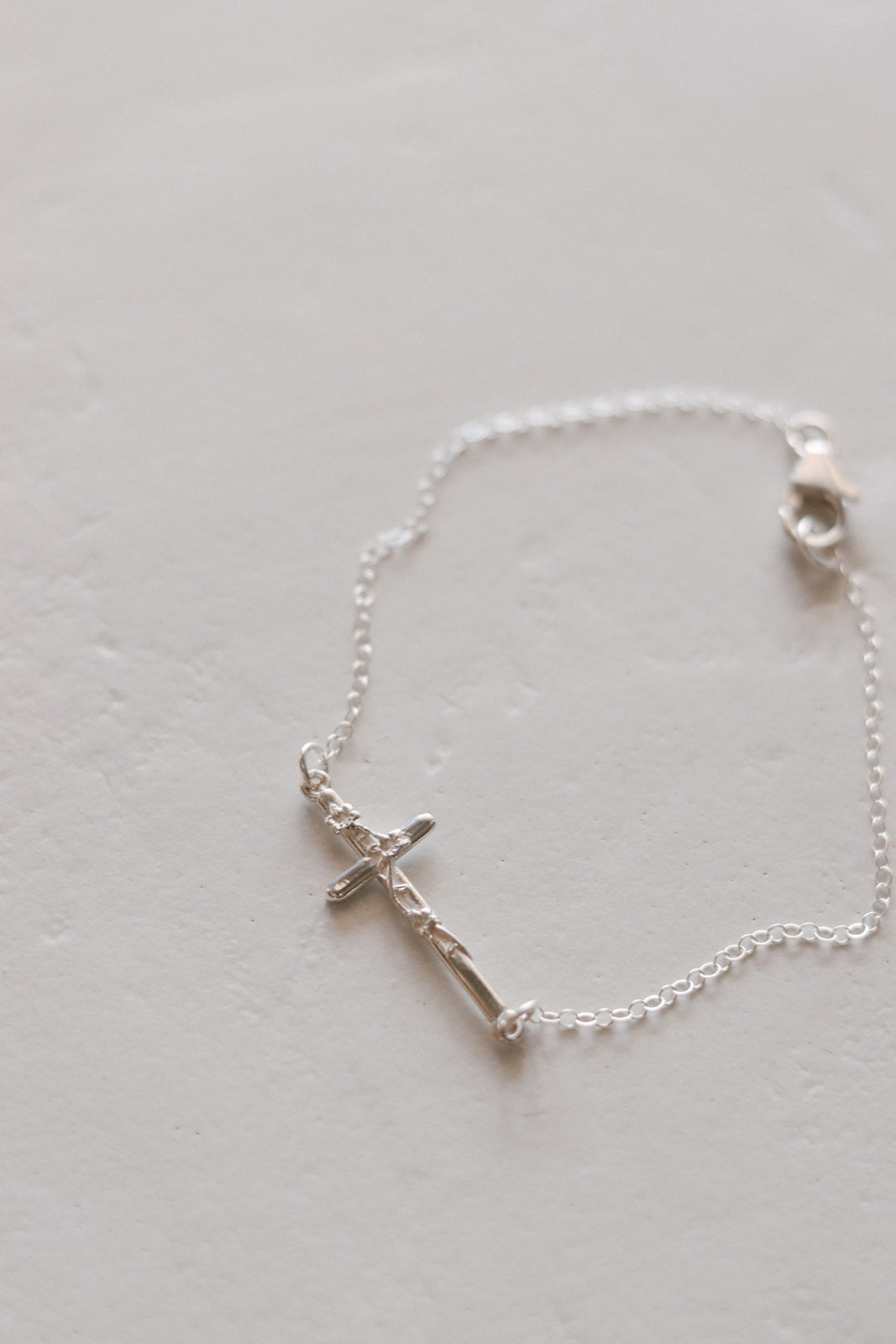 Silver cross bracelet with cross pendant, fine chain, and round clasp