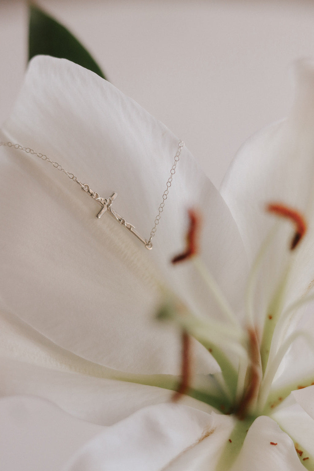Silver lily cross necklace with delicate chain and small cross pendant