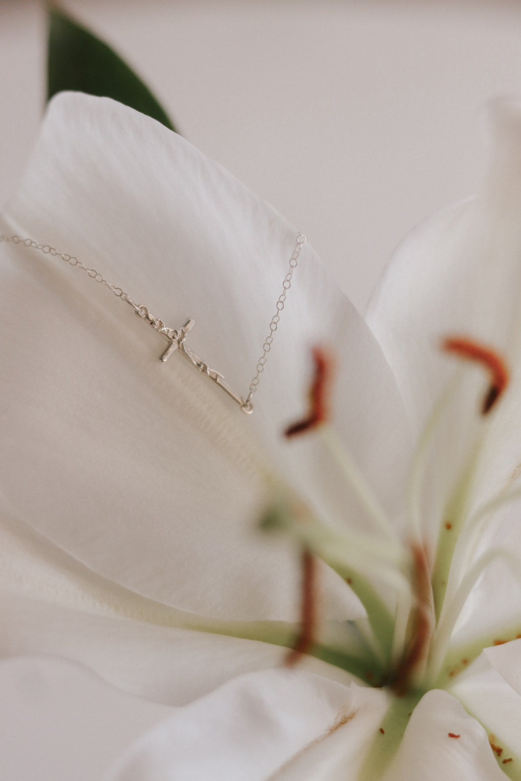 Silver lily cross necklace with delicate chain and small cross pendant