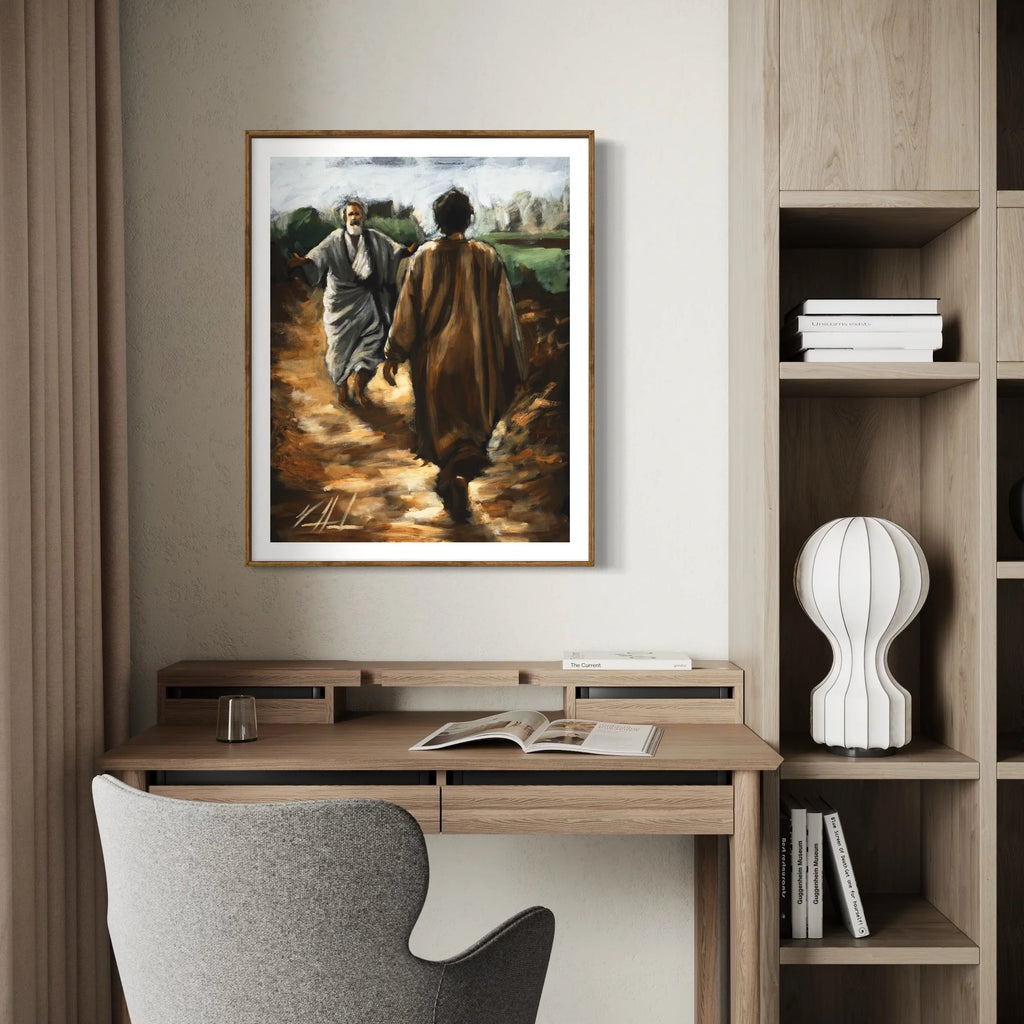 Framed artwork print of two men walking on a dirt path on a home office wall