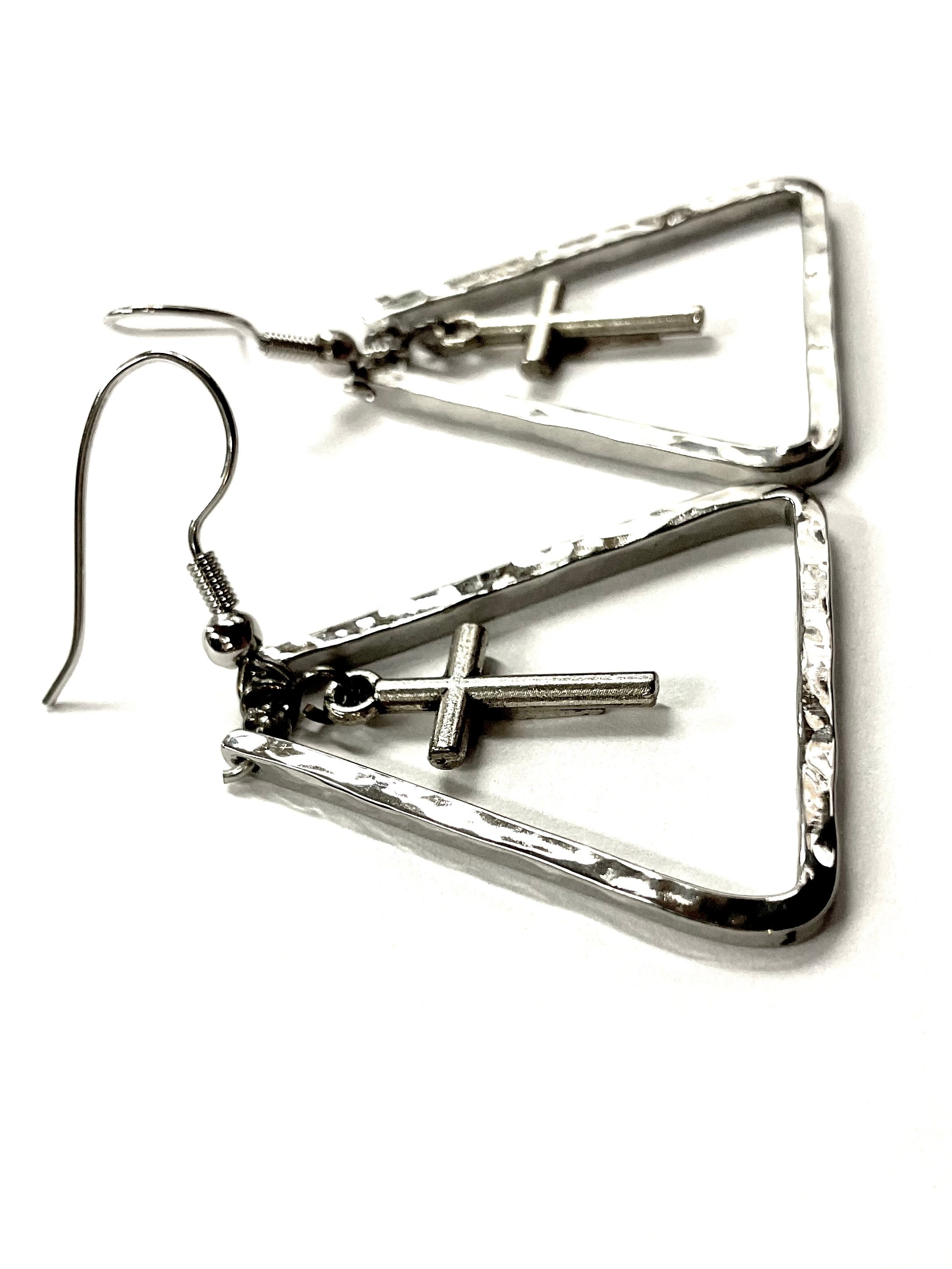 Silver triangle dangle earrings with cross bar detail and hammered texture close-up