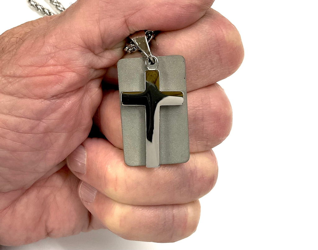 Silver cross dog tag necklace pendant close-up showing side bail