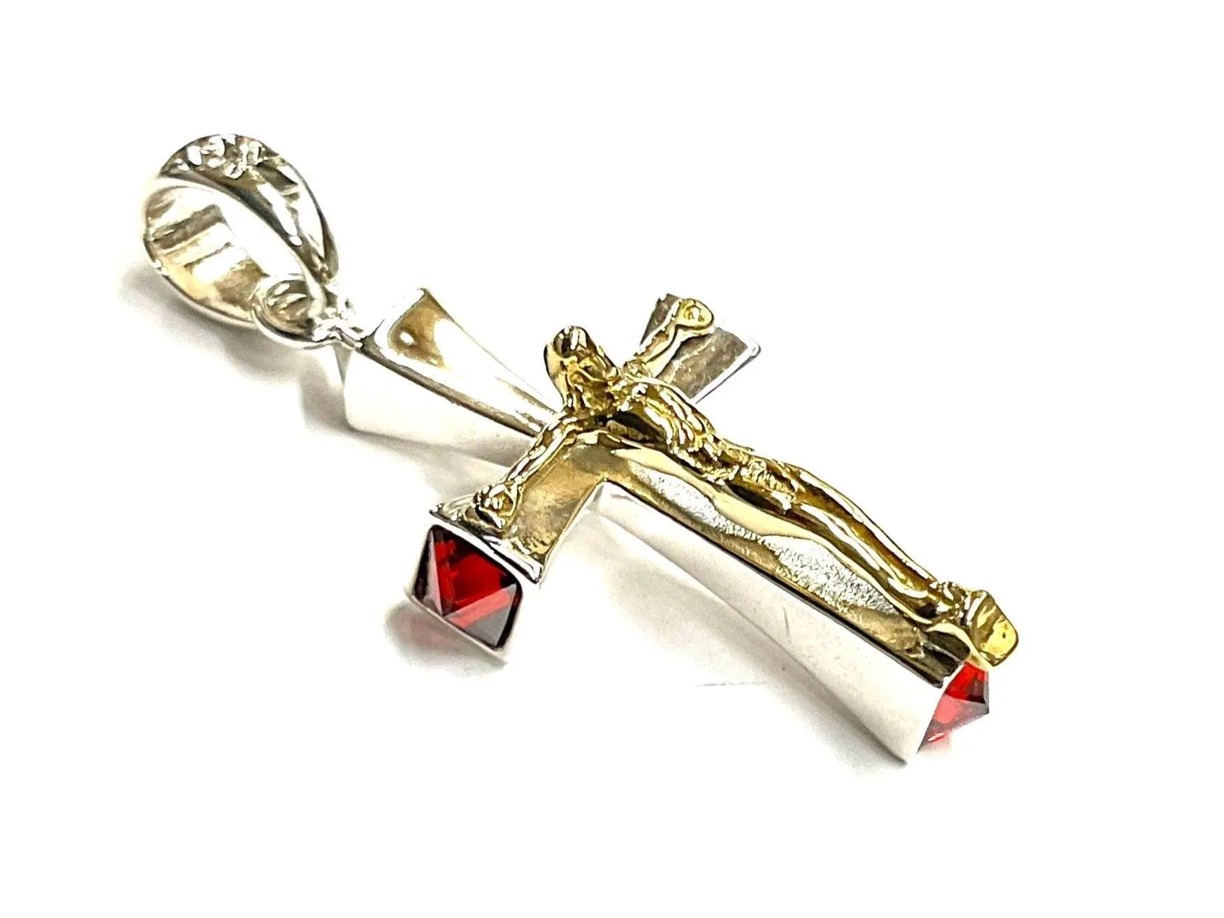 Crucifix cross pendant with red zircon stones in silver and gold-tone