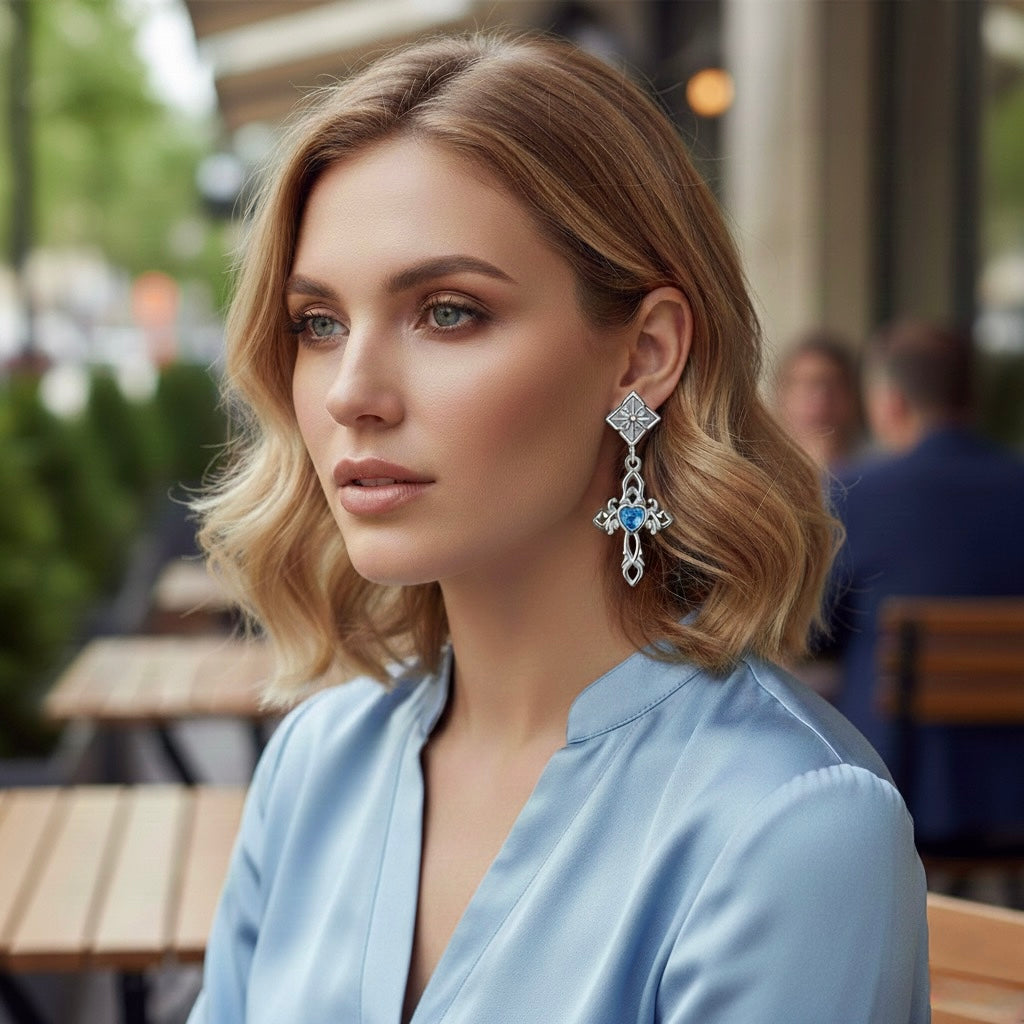 Blue zircon sacred heart dangle earrings in sterling silver with cross accents