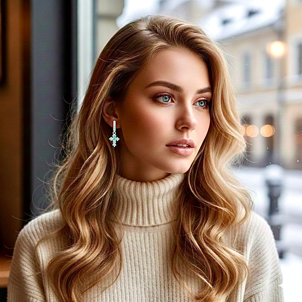 Turquoise cross hoop earrings with dangling cross, gold-tone, on ear