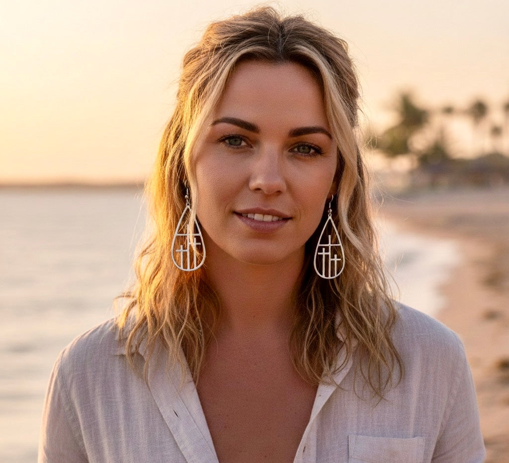 Gold-tone teardrop cross drop earrings with geometric grid cross details