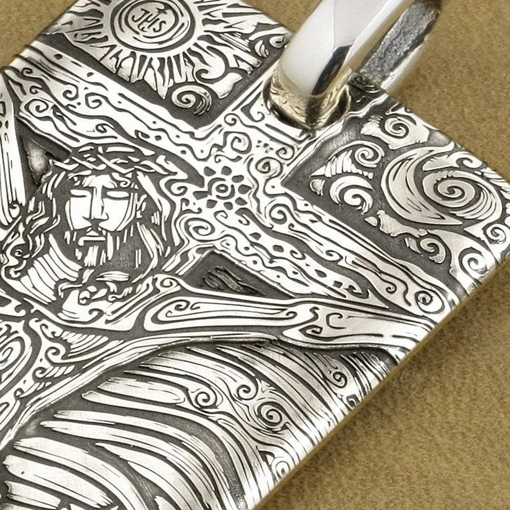 Sterling silver dog tag pendant close-up, engraved Jesus cross and decorative details