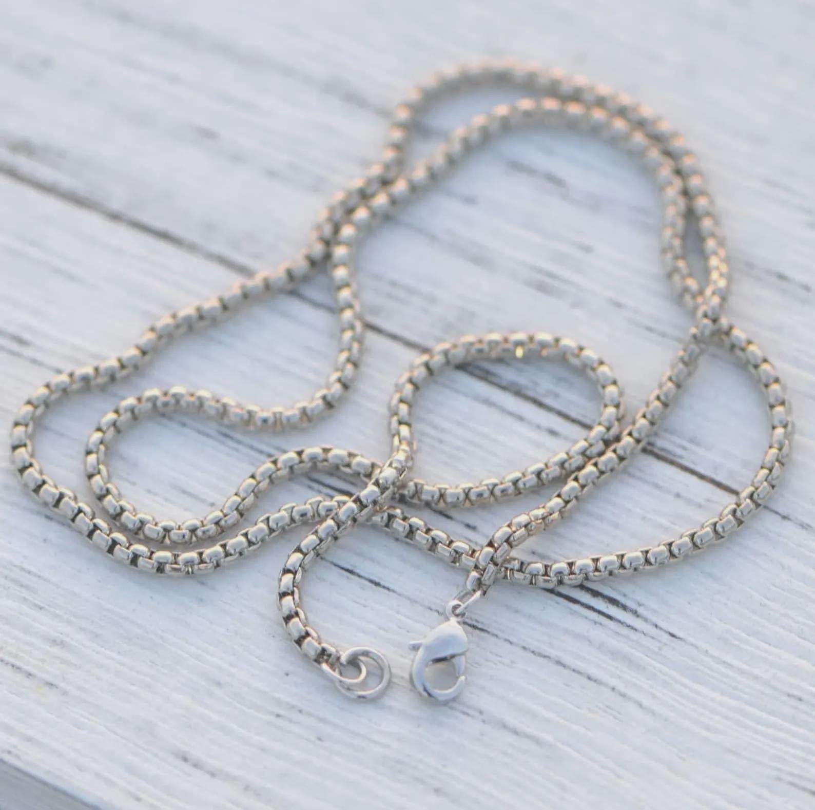Silver-tone box chain necklace links with clasp rings and cross pendant attachment
