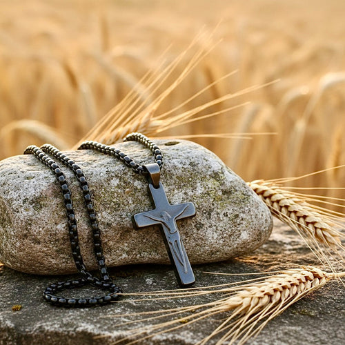 Cross pendant necklace with black beaded chains on a stone