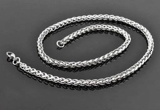 Silver curb-link chain necklace with clasp and small cross pendant