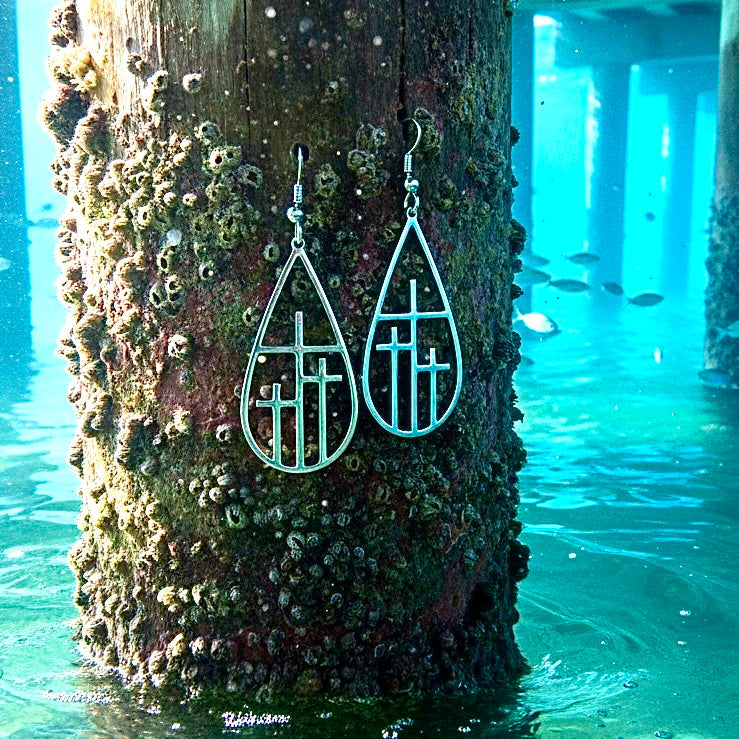 Silver-tone teardrop cross drop earrings with geometric cross cutouts