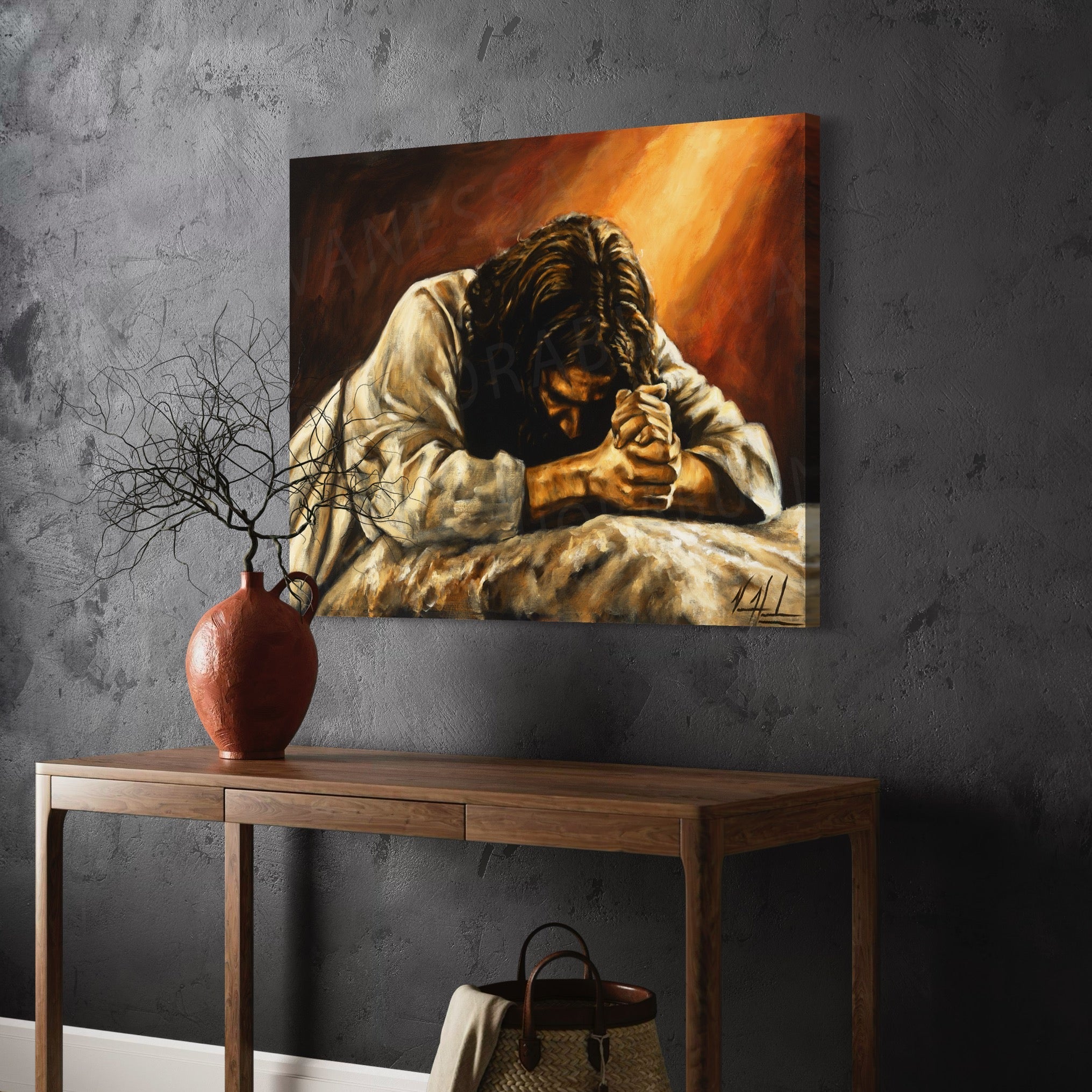 Framed giclée print of a praying man with clasped hands above a wooden console