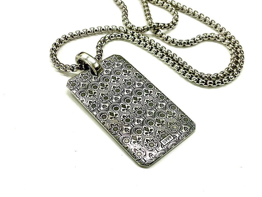 Sterling silver dog tag pendant with ornate engraving, on chain