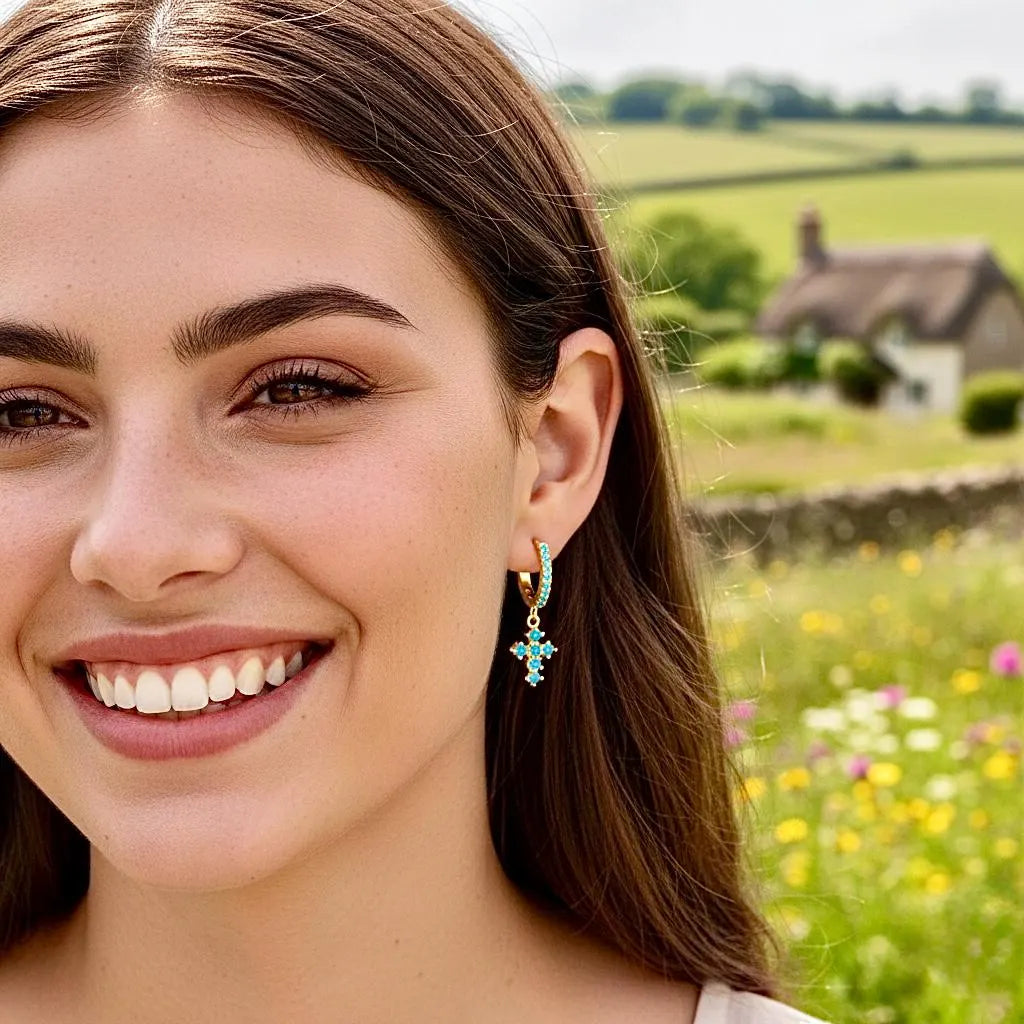 Turquoise bead cross hoop earrings with gold-tone hoops on sterling silver