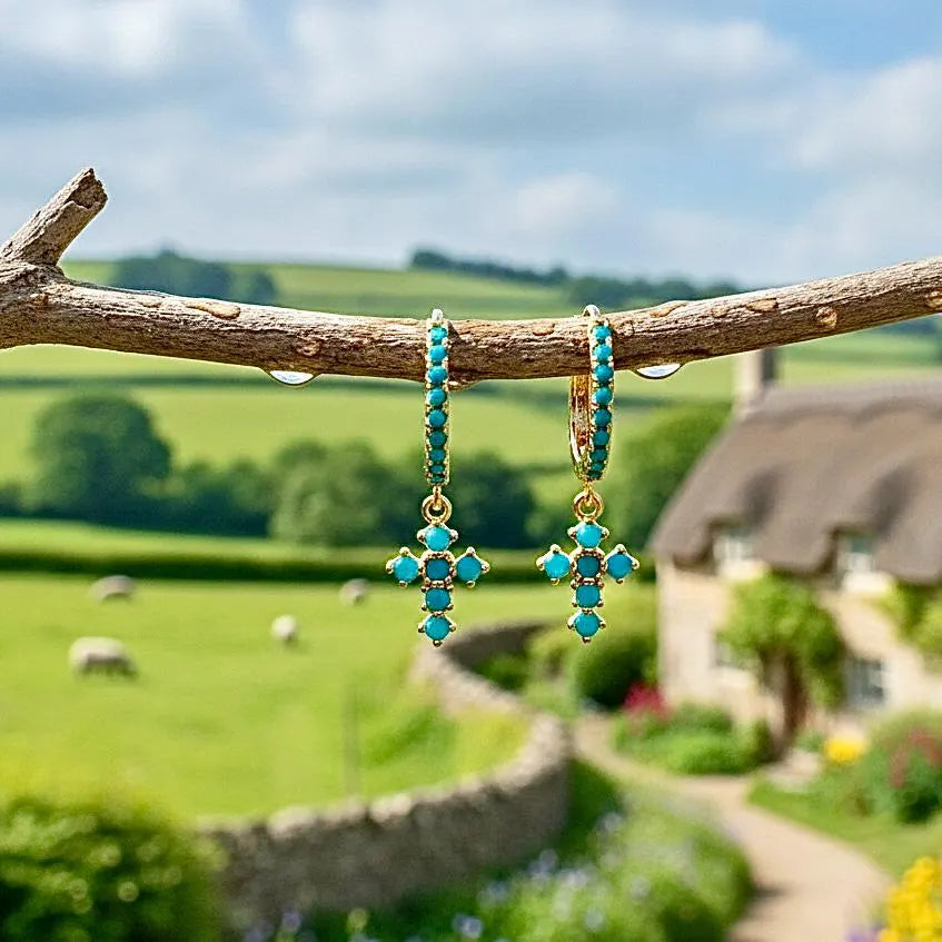 Turquoise cross drop hoop earrings on gold-tone hoops