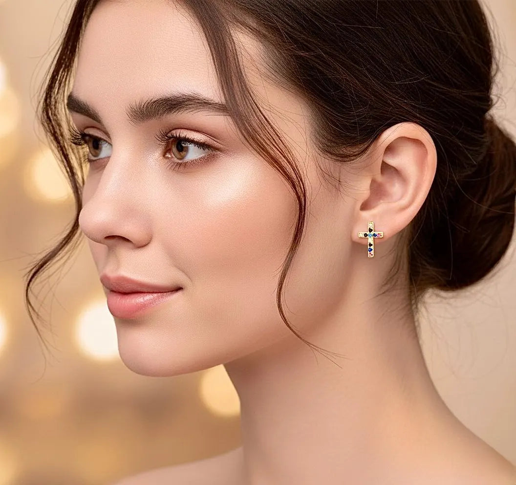 Tiny cross stud earrings with clear crystal inlay, worn on the ear