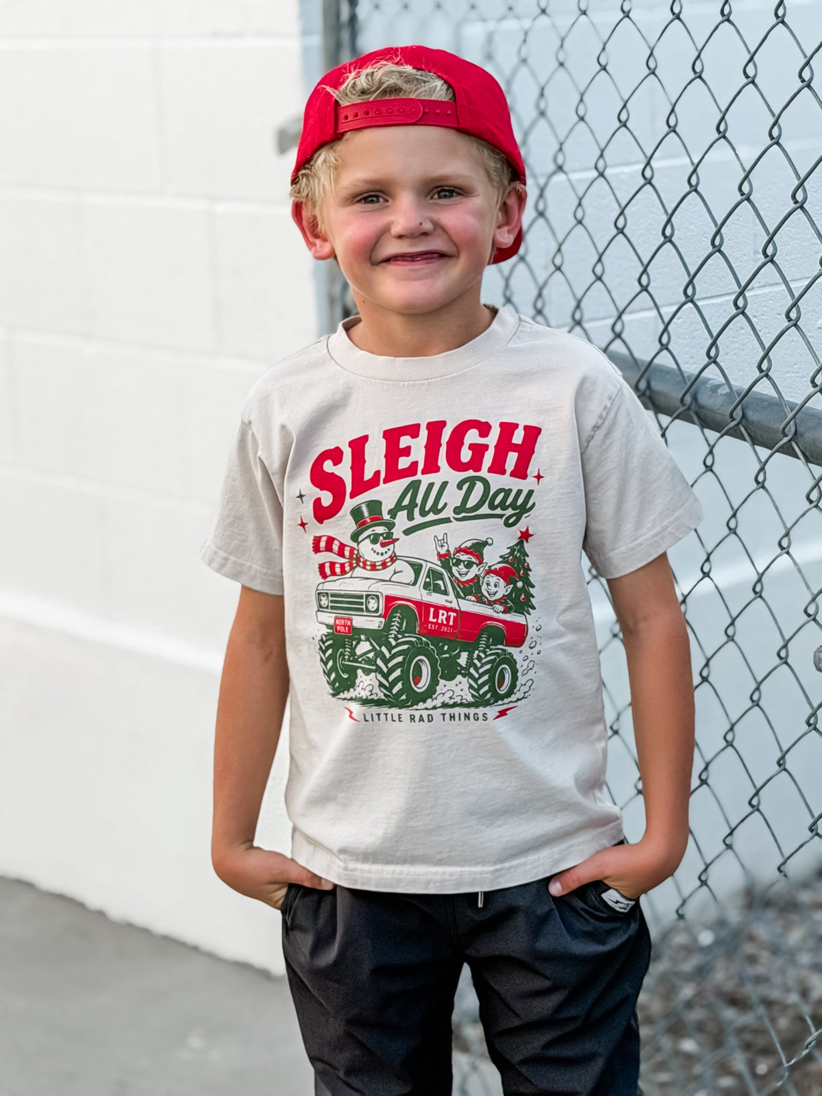 White toddler Christmas t-shirt with “Sleigh All Day” monster truck graphic