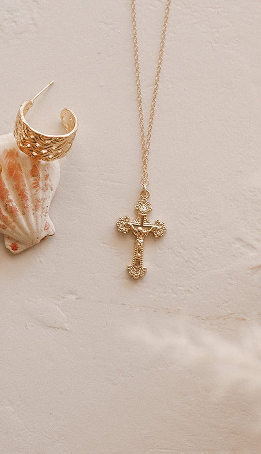 14k gold crucifix necklace with delicate chain and small cross charm.