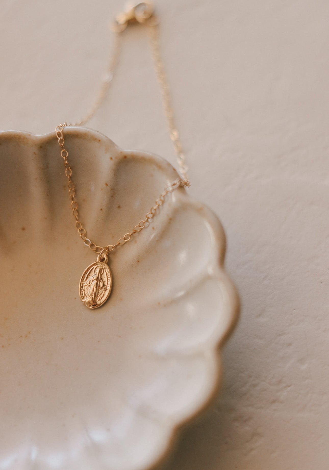 14K gold bracelet with oval miraculous medal pendant on thin chain