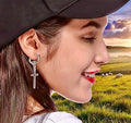 Silver-tone hoop earrings with dangling Celtic cross charm