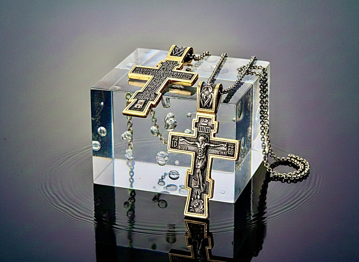 Gold and silver-tone cross pendant necklace with chain, ornate eastern design